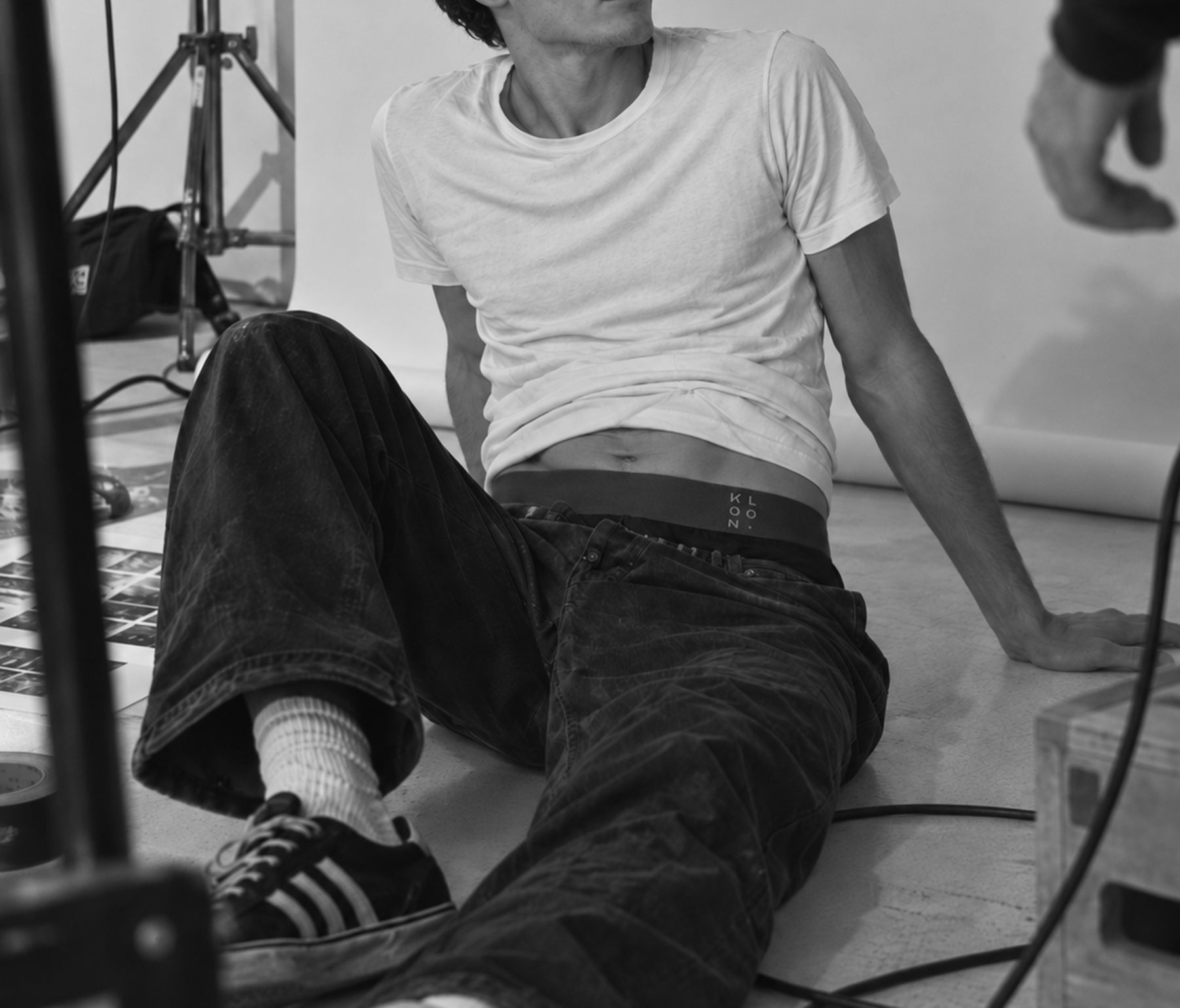 Behind the scenes, KLOON waistband visible above baggy jeans on set